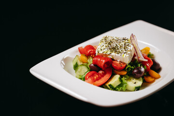 Greek salad with kalamata on a black background
