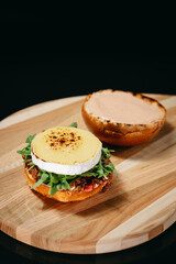 Hot snack with Brie cheese on a black background