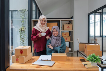 two muslim woman working online sales of they made at home. small business muslim selling online