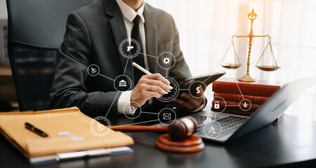 justice and law concept.Male judge in a courtroom  the gavel, working with smart phone and laptop...