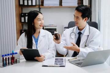 Medical technology network team meeting concept. Asian Doctor hand working with smart phone modern...
