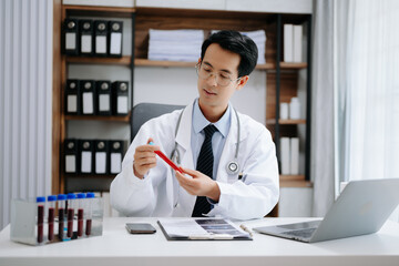 Attractive female doctor talking while explaining medical treatment to patient through a video call with laptop in modern office