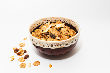 Muesli with raspberries and milk in a bowl on a white background. Healthy breakfasts, proper nutrition