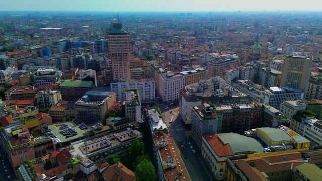 Aerial view of a 1950s mushroom-shaped high-rise building containing shops, offices and private apartments. Velasca Tower. Roofs. Flight over buildings in the metropolis. Italy, Milan, 07.2023