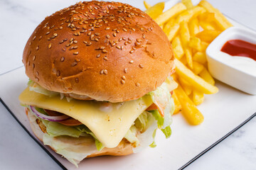 Chicken cheeseburger and fries on tray - obrazy, fototapety, plakaty