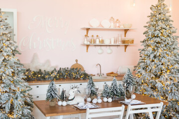 Wooden tabletop with cutting board and blurred kitchen with Christmas tree. Background for display or montage your products