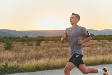 A young handsome man running in the early morning hours, driven by his commitment to health and...