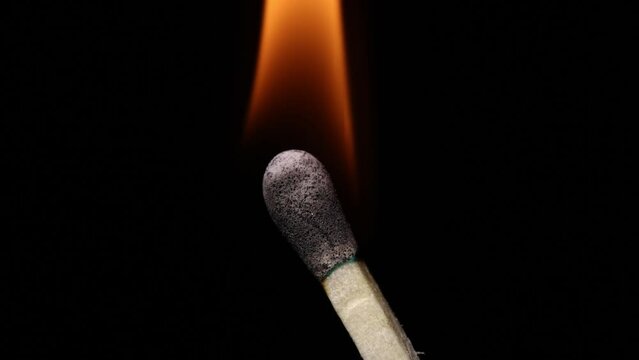 Slow motion shot, lighting and burning a match