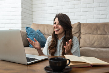 Young smart intelligent student woman sitting at home on floor working as freelancer distant...