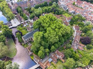 Aerial drone view of the Princely Beguinage Ten Wijngaerde, minnewater park and bridge. It is the...