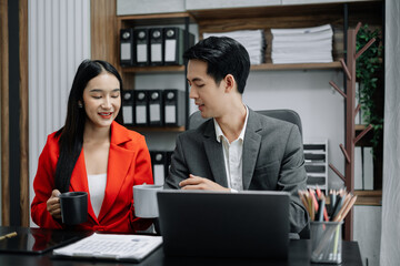 colleague Asian descent holds a cup of coffee and smiles happily.