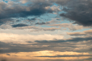 Cumulus clouds and gaps of clear blue sky.