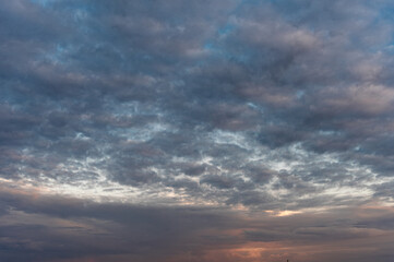 Cirrocumulus clouds and gaps of blue sky.