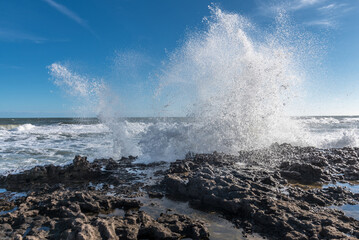 View of the sea waves crashing on rocks. Summer and travel concept.