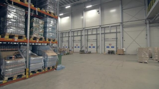 drive through steadicam wide shot of warehouse with shelves full of various packages and goods