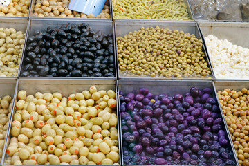 variety selection of marinated and pickled olives in a food stall for selling