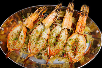 grilled mediterranean style jumbo tiger prawns or shrimps in a copper food pan