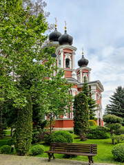 View of Orthodox Cathedral with black domes in monastery against cloudy sky. Kurki Monastery in Moldova was founded in 1773. Concept religion, christianity, orthodoxy. © Marina_Nov