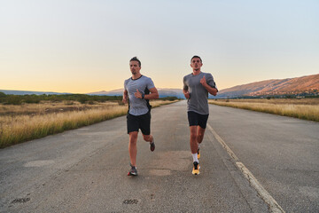 Group of handsome men running together in the early morning glow of the sunrise, embodying the essence of fitness, vitality, and the invigorating joy of embracing nature's tranquility during their