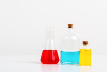 some test tube on the white table with beakers, flasks, and test tubes filled with colorful liquids