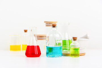 some test tube on the white table with beakers, flasks, and test tubes filled with colorful liquids
