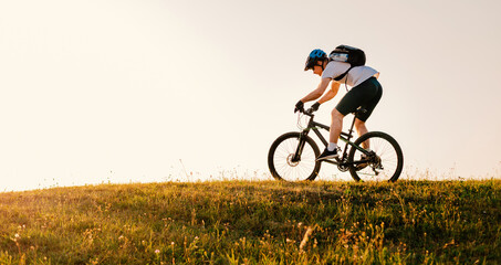 Professional mountain bike cyclist riding on white background active lifestyle.