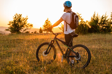 Professional mountain bike cyclist riding a forest trail active lifestyle adventure sport outdoor.