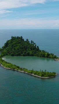 Beautiful landscape of Cabugao Island and blue sea. Blue skies and clouds. Mindanao, Philippines. Vertical view.