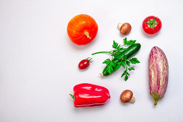 Creative layout of zucchini, bell peppers, sherry tomatoes, tomatoes, cucumbers, parsley branch and mushrooms on a white background. Food concept. Healthy food. View from above.