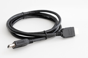 HDMI Cable for connecting a computer to a monitor and other multimedia consumer electronics, close-up in selective focus on a white background