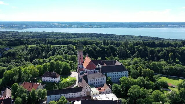 Drone video of Andechs Monastery with a view of Lake Lake Ammer in the background. Andechs, Starnberg, Upper Bavaria, Bavaria, Germany, Europe
