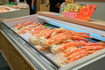 King crab legs on ice selling at market in Osaka, Japan. Street food and travel concepts.