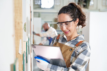 Attractive female carpenter workers standing and looking at the camera with smiling in carpentry...