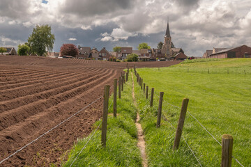 Fototapeta na wymiar Hilly landscape with church of Scheulder in South Limburg, the Netherlands