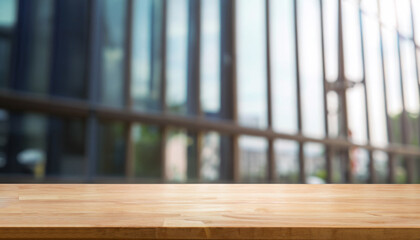 Wood table top on blur glass window wall building background. For montage product display or design key visual layout background.