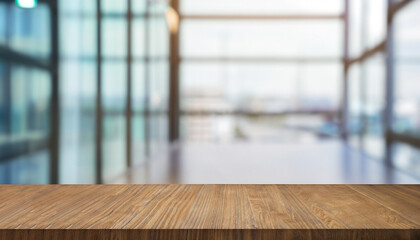 Wood table top on blur glass window wall building background. For montage product display or design...