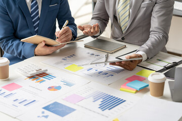 Team of business investment consultant analyzing company annual financial report working with...