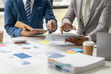 Team of business investment consultant analyzing company annual financial report working with...