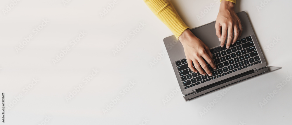 Canvas Prints close-up portrait typing keyboard on laptop computer. working online on white table at office. faceb