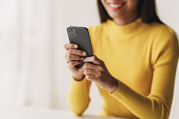 Portrait of a young woman holding a mobile phone to use social media on a smartphone. Communicate...