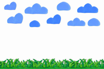green grass and blue cloud with made from plasticine on white