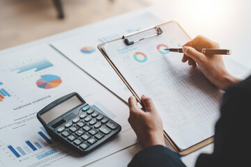 Accountant working on desk using calculator to calculate financial report in office business accounting finance concept