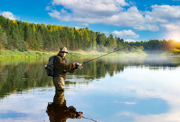 A fisherman is fishing in the Volga River. Russia, summer.