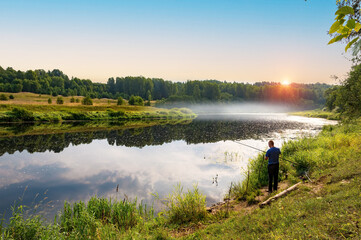 In the early summer morning, a fisherman is fishing in the upper reaches of the Volga River.