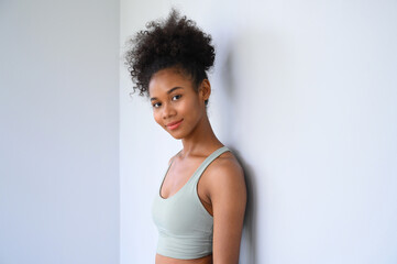 Beautiful young African American girl posing with fitness clothes over white background. Healthy and Fitness concept.