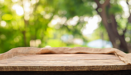 table wood for coffee product, Empty wooden table and sack tablecloth over blur park, garden...