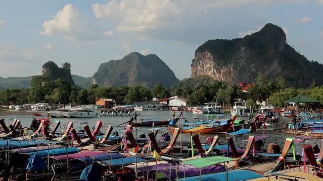 Krabi / Thailand - March 17, 2023: Fishing and tourist boats on the background of the mountains