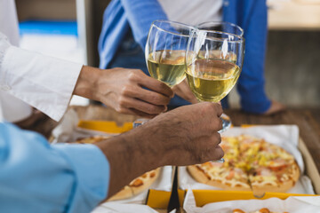 Cheers, clink glasses, Friends having a drink to celebrate at a small party in their home office.