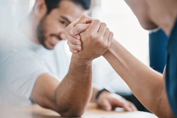 Strong, hands and closeup of men arm wrestling on a table while being playful for a challenge....
