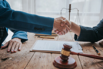 Businessman shaking hands to sign agreement with lawyer or his partner lawyer to discuss contract...